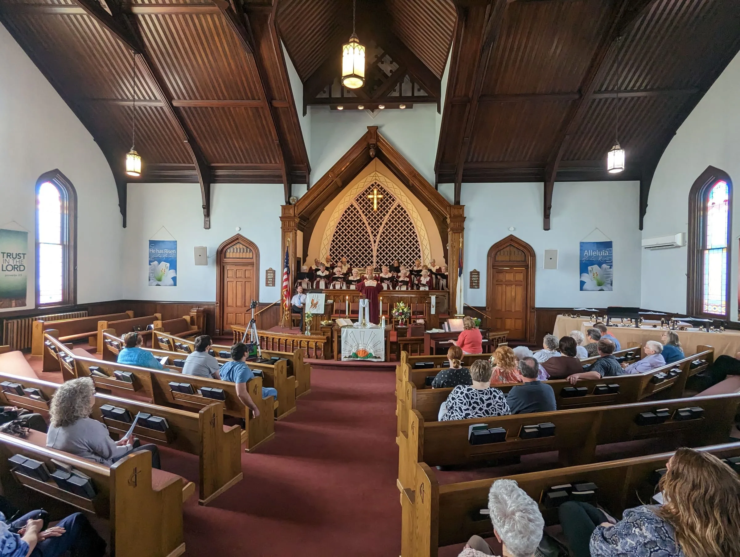The sanctuary, with its wooden ceiling and stained glass windows